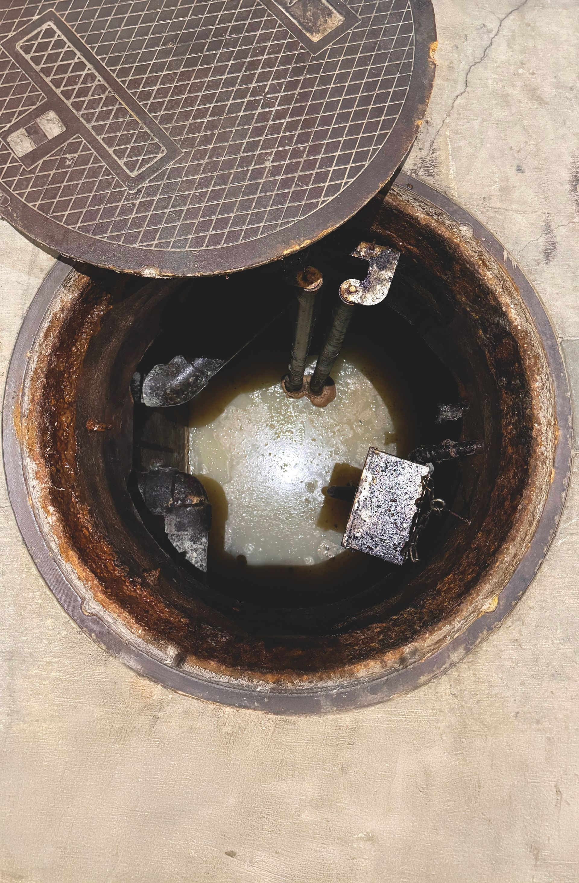 A manhole cover with water coming out of it.