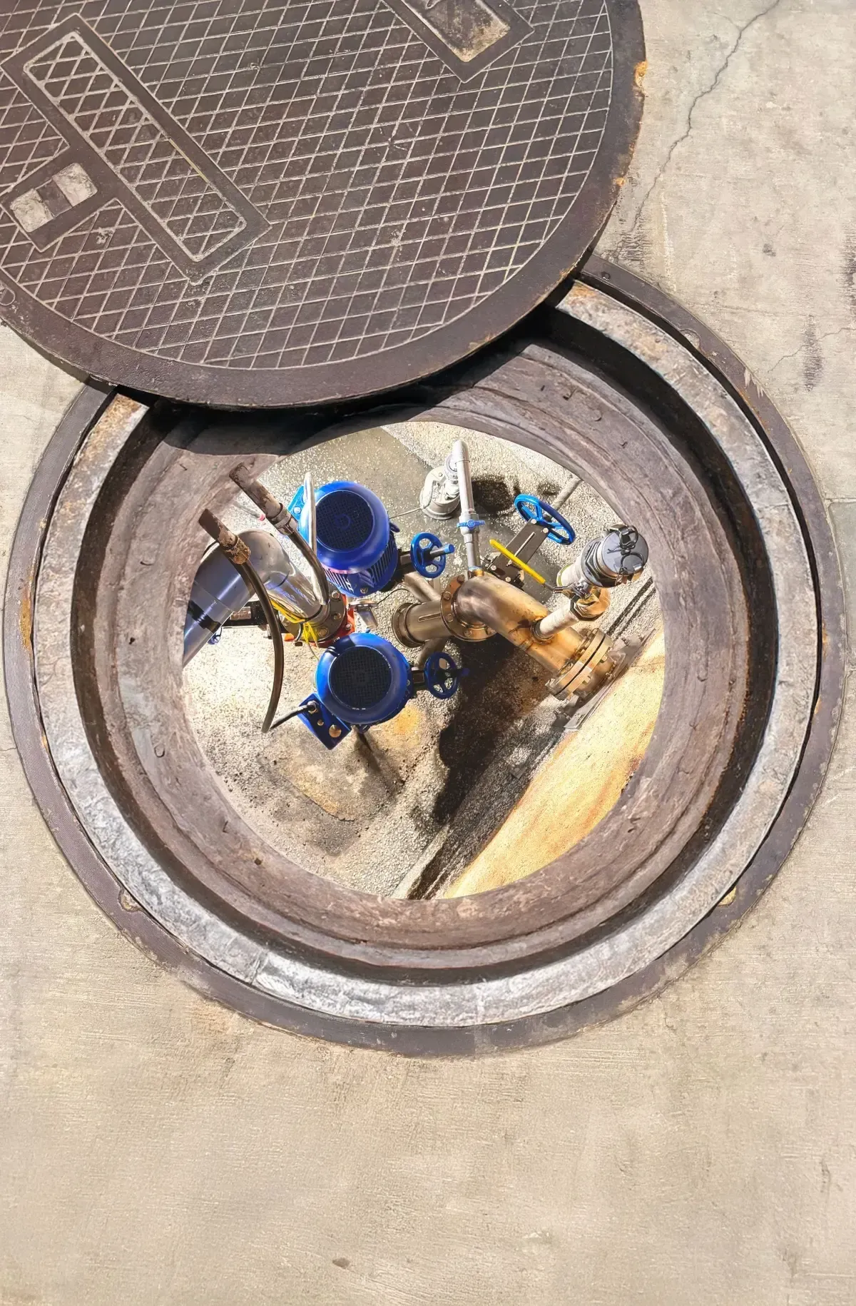 After: OverWatch direct in-line system installed below the same manhole