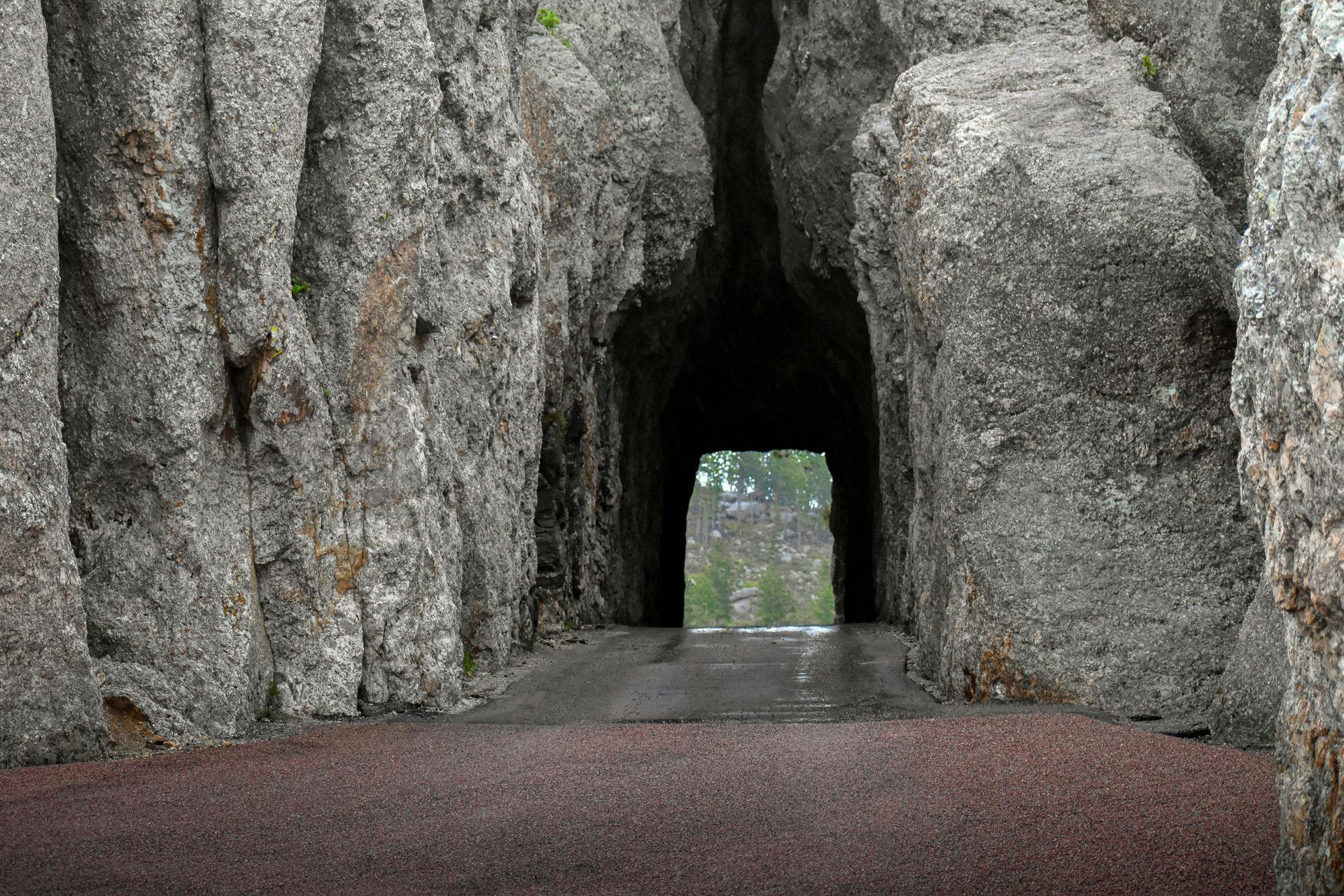 A large splash of water is coming out of a hole in the ground.