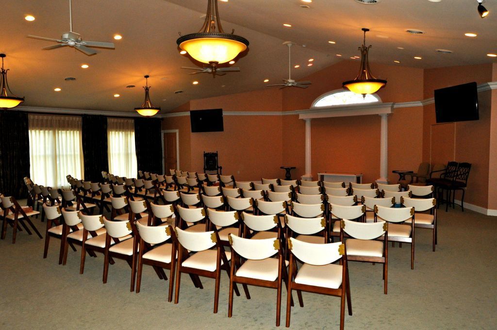 Rows of chairs are lined up in a large room