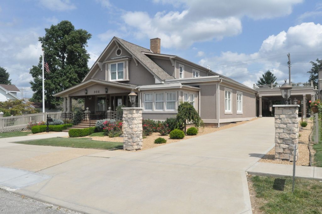 A large house with a lot of windows and a driveway