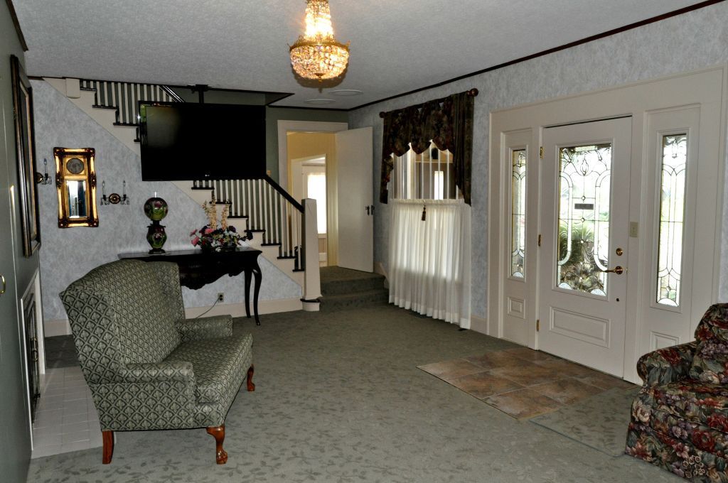 A living room with a couch a chair and stairs