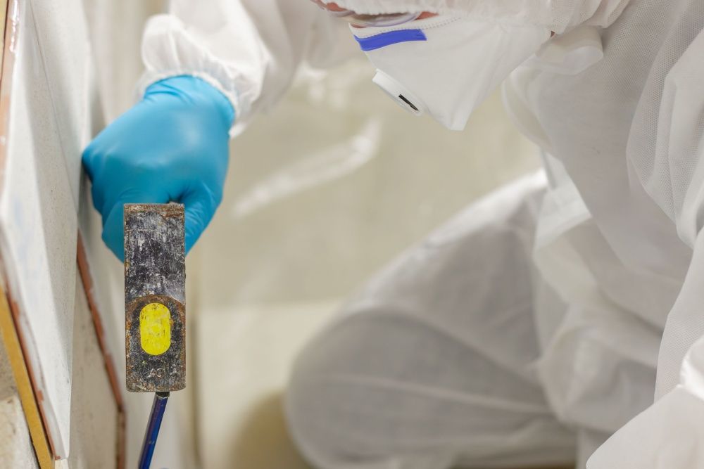 Diagnostic test kit: white and yellow boxes, tubes, and testing strips on a reflective surface.