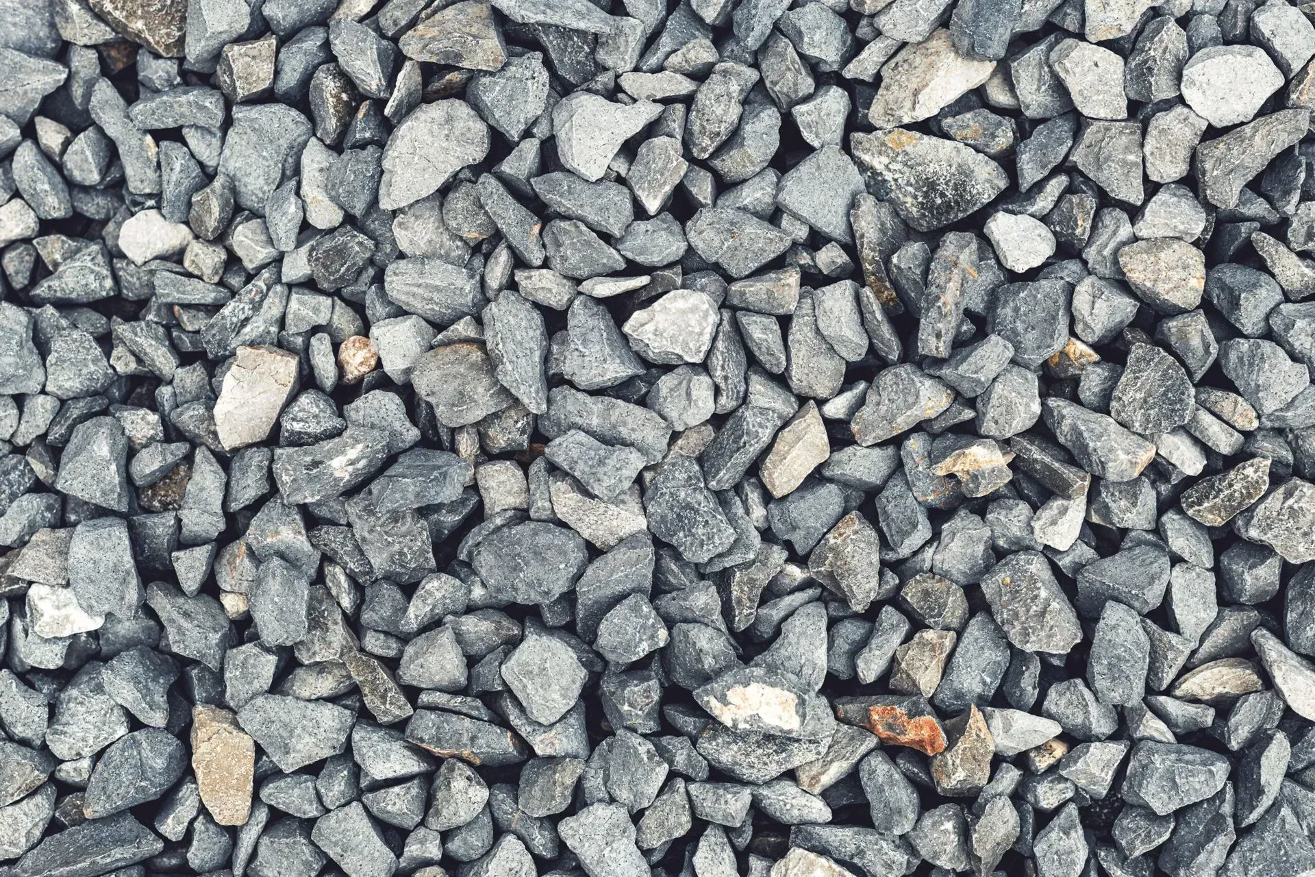 A stream of rocks runs through a lush green field.