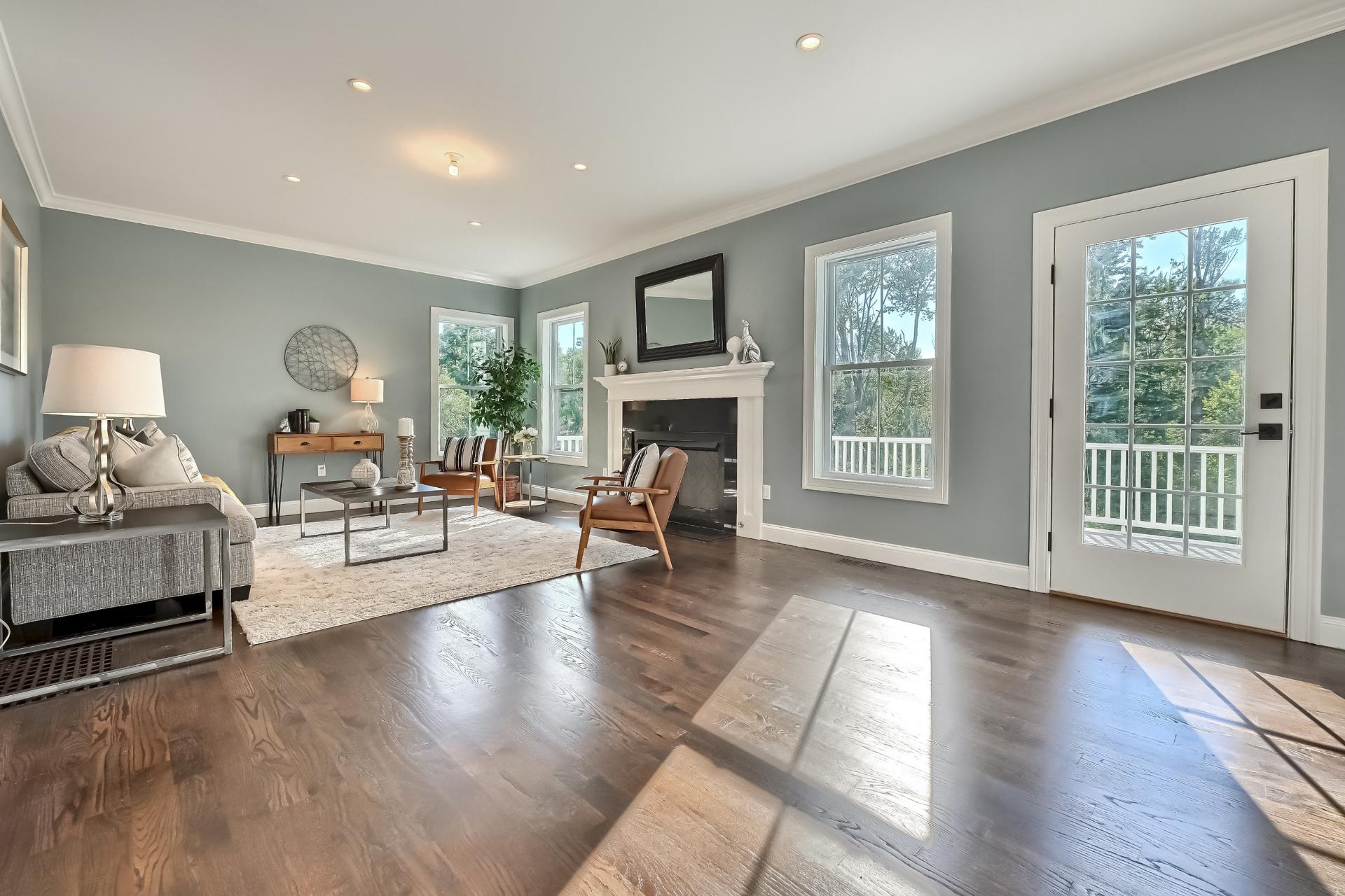 A living room with a fireplace and lots of windows