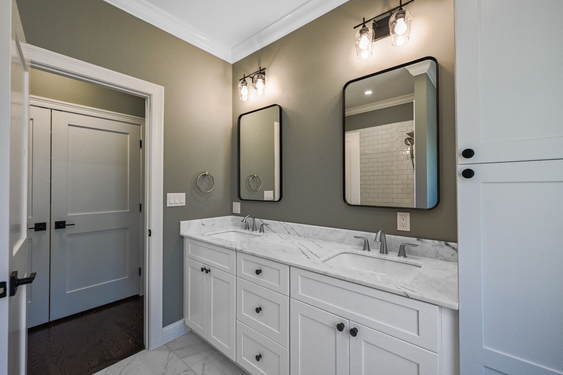 A bathroom with two sinks and two mirrors.