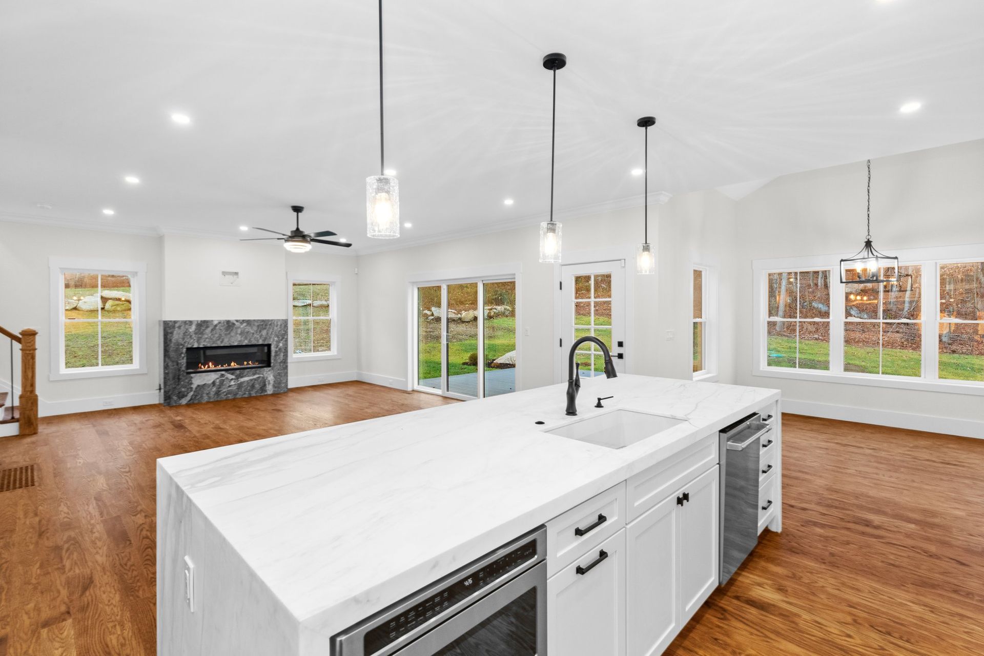 A kitchen with a large island and white cabinets