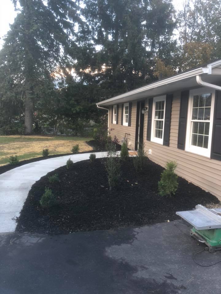 A house with a concrete walkway leading to it