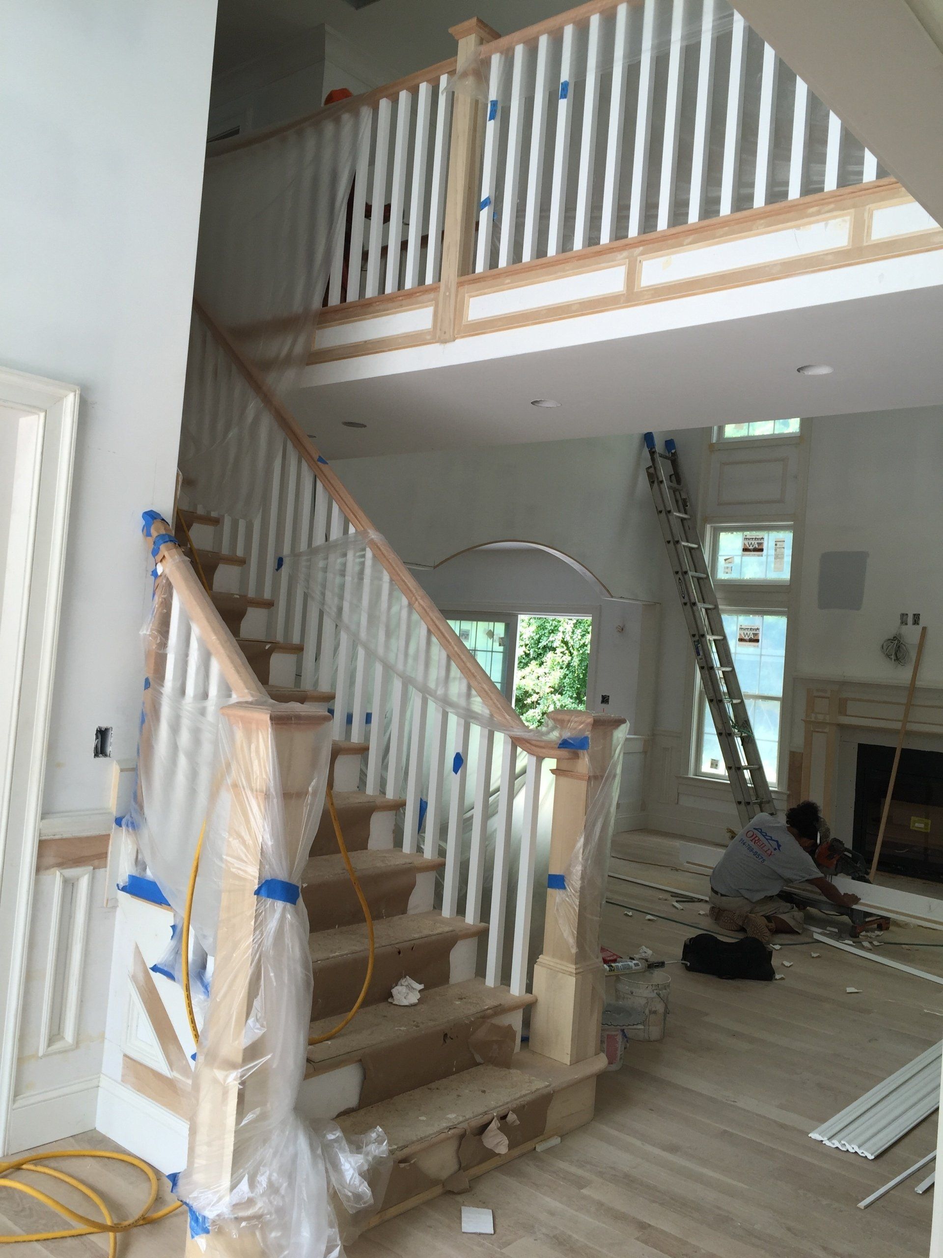 A man is working on a staircase in a house