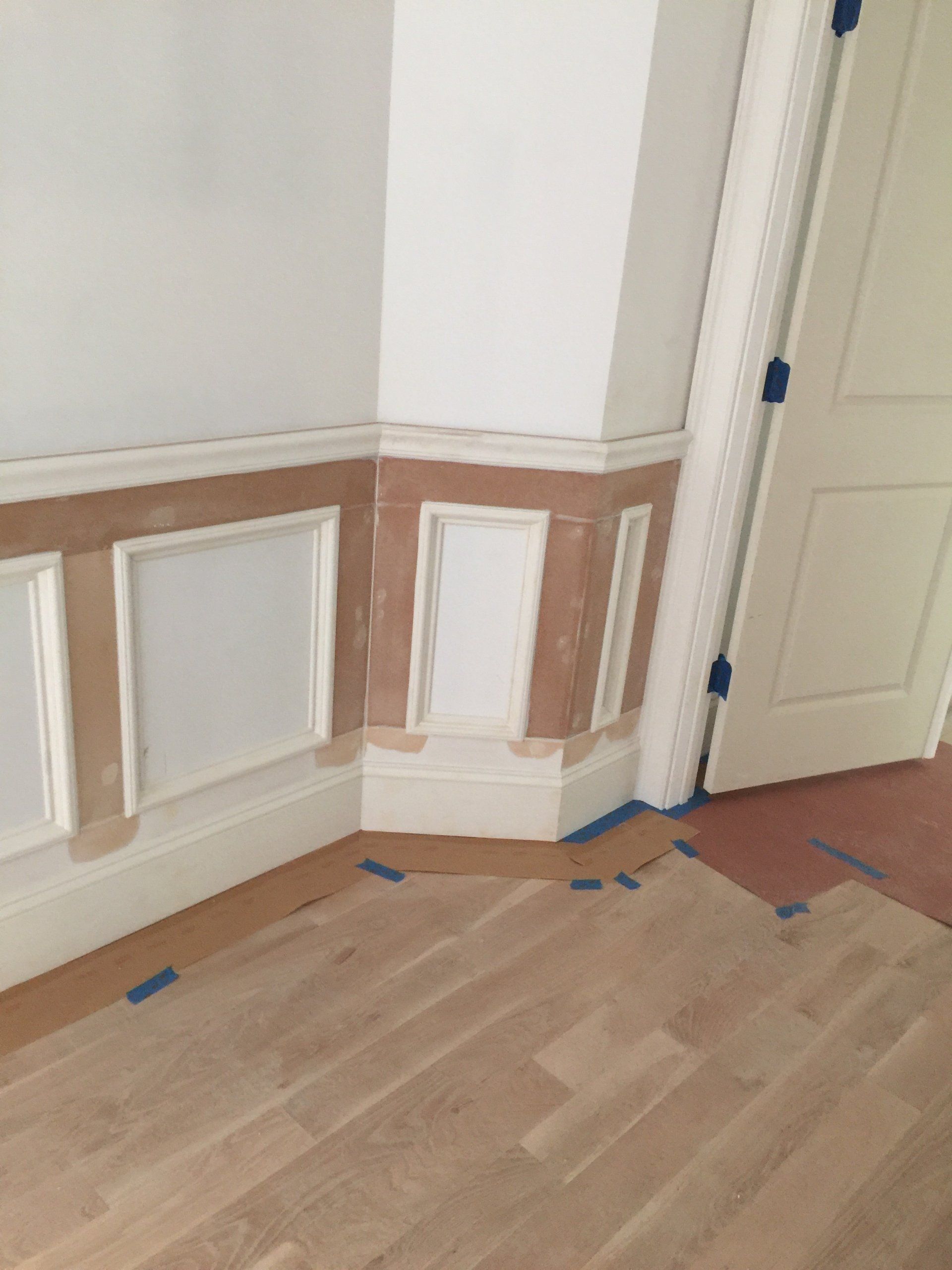 A room with a wooden floor and white walls