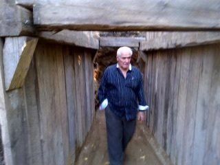 A man is walking through a tunnel.