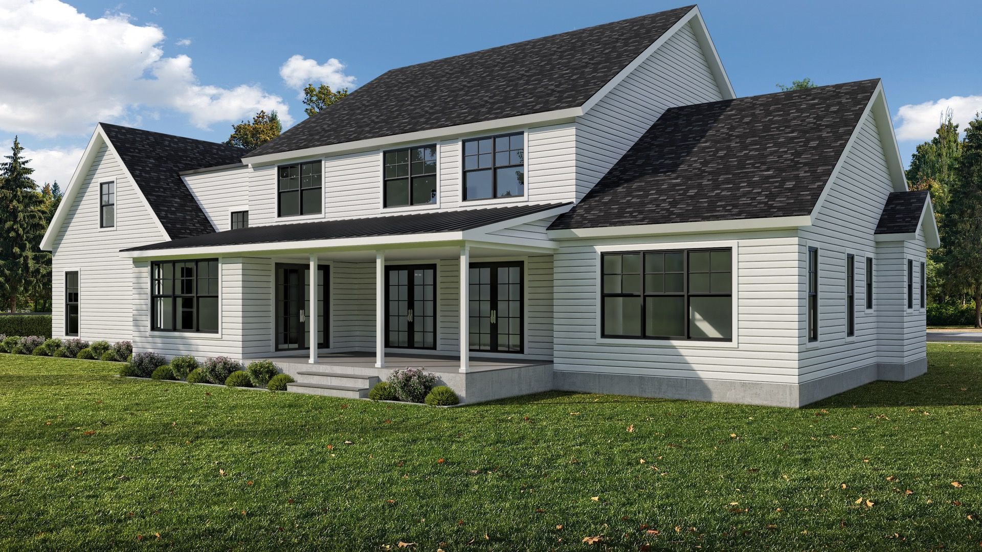 A white house with a black roof is sitting on top of a lush green field.