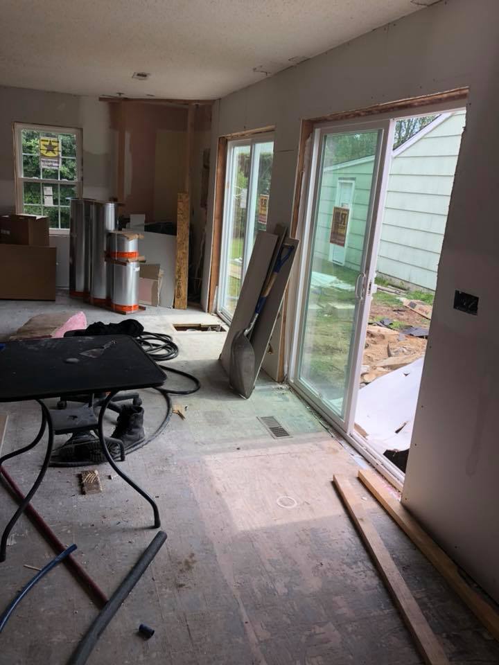A room with sliding glass doors and a table in it.