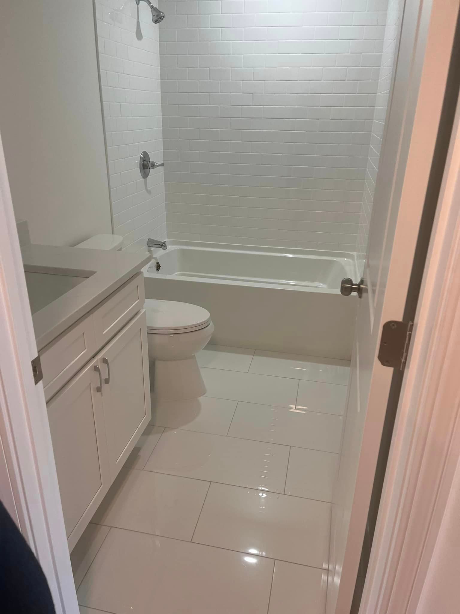 A bathroom with a toilet , sink , bathtub and shower.