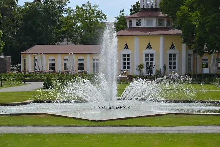 A fountain is spraying water in front of a building