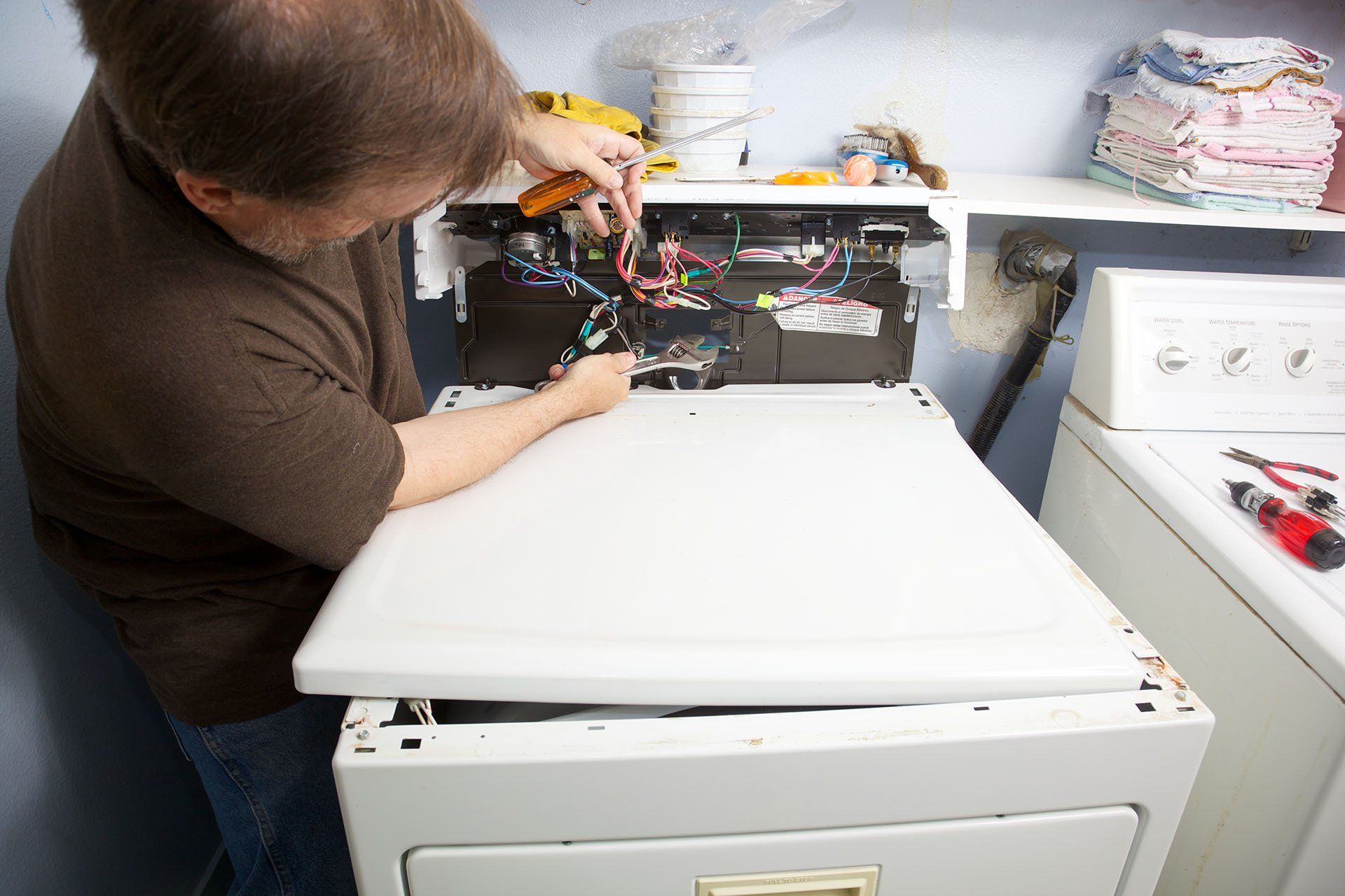Man repairing a dryer — Concord, NC — Barbee Appliance Repair