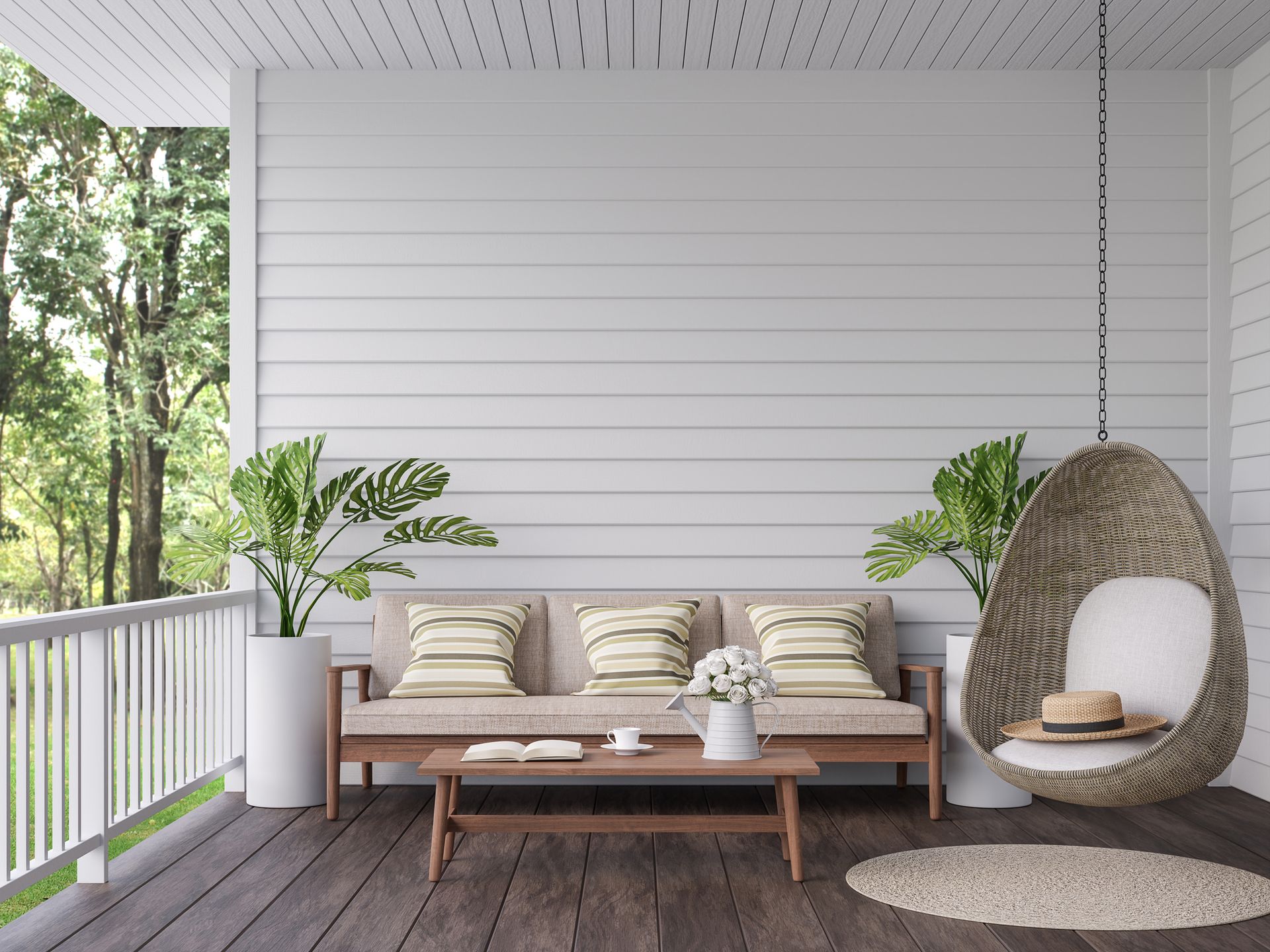 A porch with a couch , table , chair and potted plants.