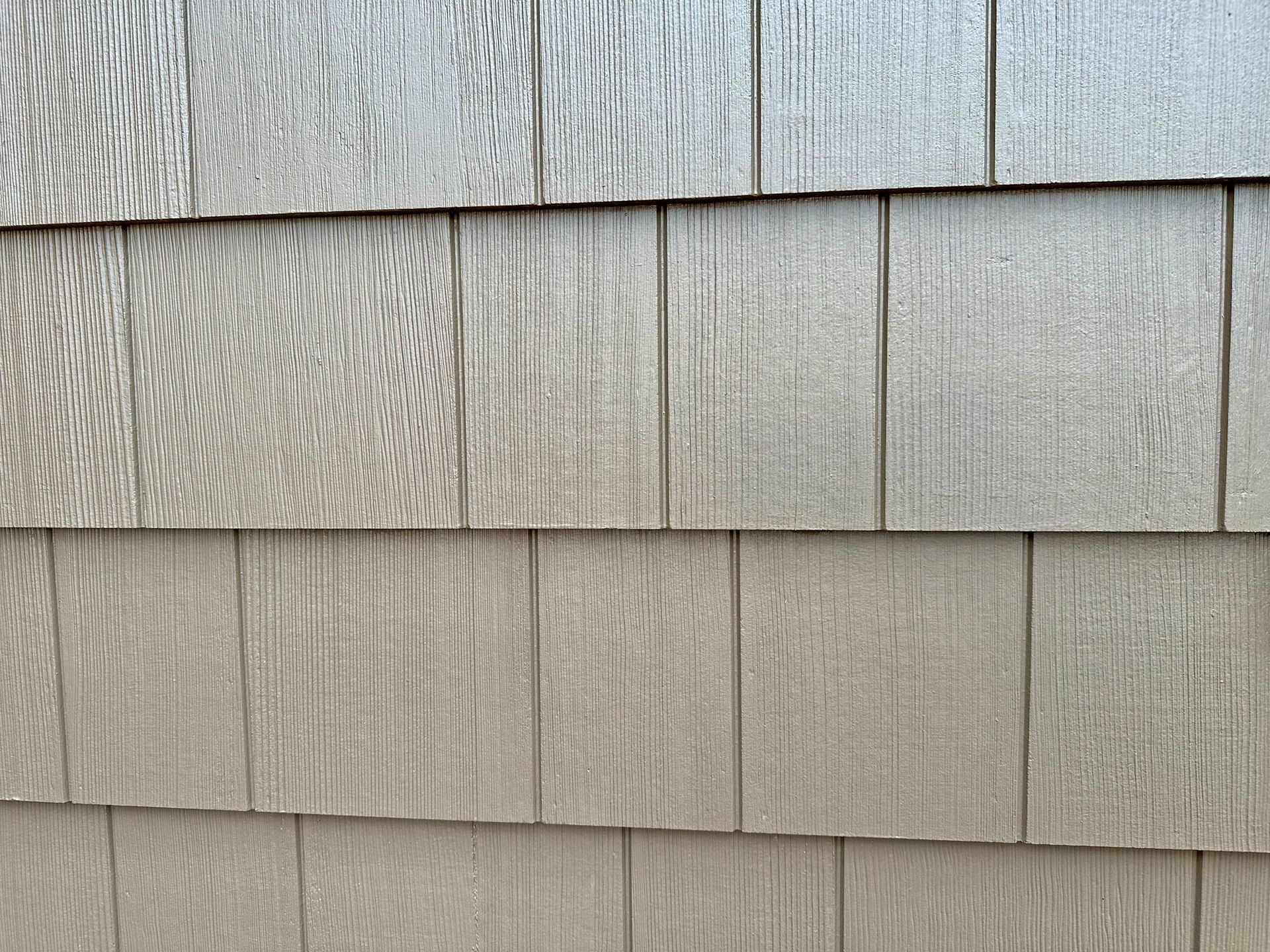 A close up of a wooden siding on a house.