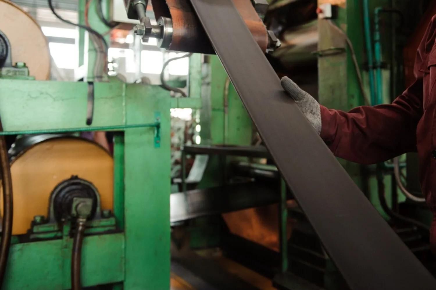 A Man Is Working On A Machine In A Factory — HardRok Engineering Pty Ltd In Mount Isa, QLD