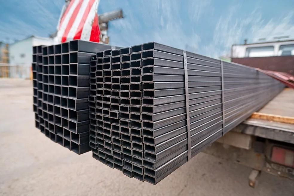 A Stack Of Metal Pipes Sitting On The Back Of A Truck — HardRok Engineering Pty Ltd In Mount Isa, QLD