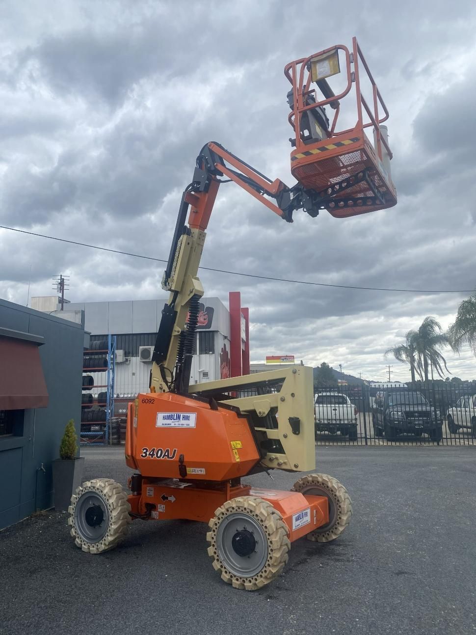An Orange Jlg Lift is Parked in a Parking Lot — Hamblin Hire in Albury, NSW