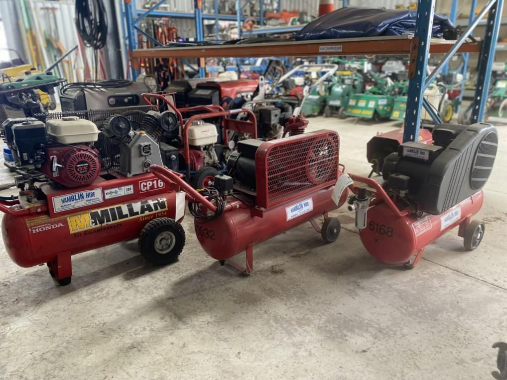 Three Air Compressors Are Sitting Next to Each Other in a Warehouse — Hamblin Hire in Albury, NSW