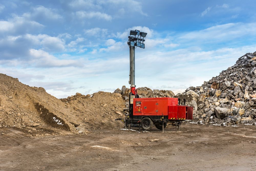 Red Mobile Light Tower Stands in a Construction Site