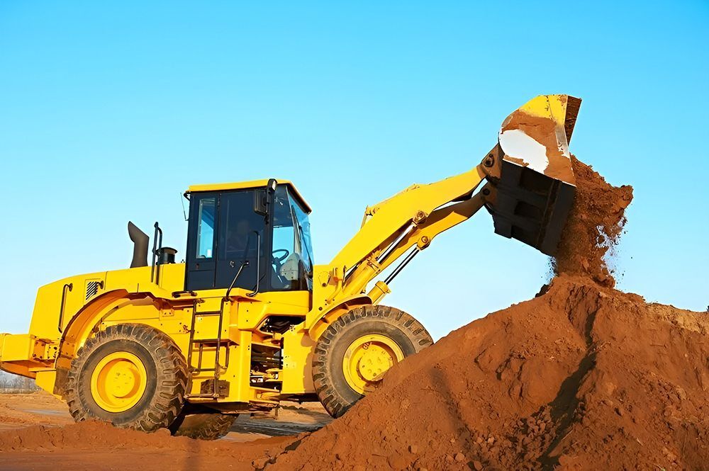 A Yellow Bulldozer is Loading Dirt into a Pile