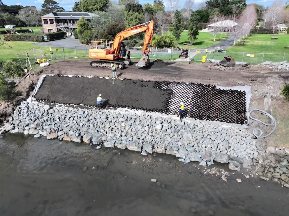 Construction Site With Excavator, Workers, and Retaining Wall — Dirt Werx in Nowra, NSW