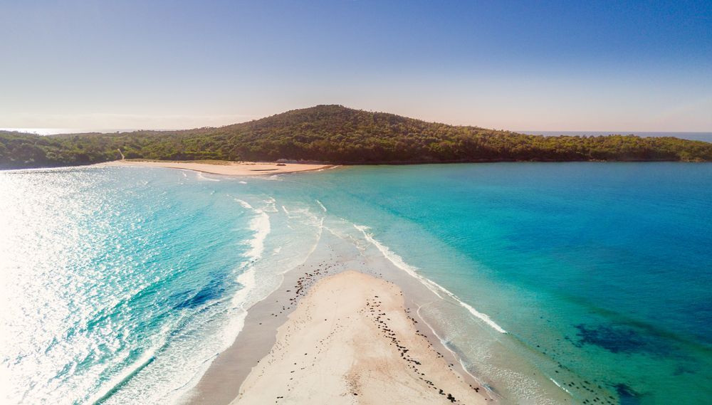Aerial View Of A White Sand Spit Between Turquoise Ocean Waters — Dirt Werx in Fingal Bay, NSW