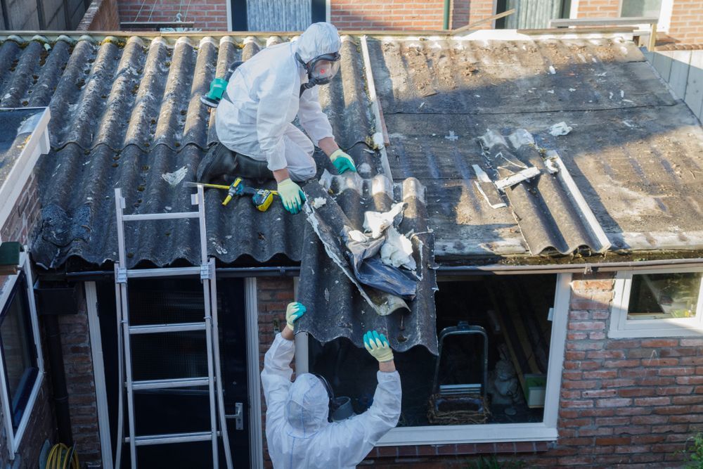 Workers In White Coveralls Remove Roofing Debris With Traces Of Asbestos — Dirt Werx in Nowra, NSW