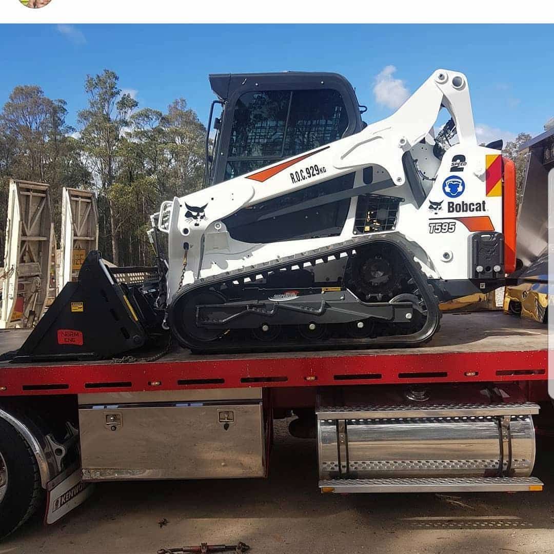 White Bobcat Skid-steer Loader With Tracks on a Red Flatbed Truck — Dirt Werx in Nowra, NSW