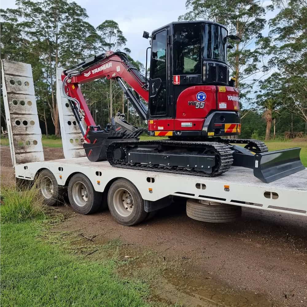 Red Excavator on a White Trailer, Parked on a Dirt Road — Dirt Werx in Nowra, NSW