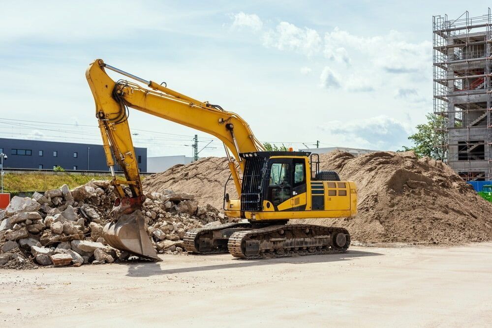 Yellow Excavator Scoops Debris at a Construction Site — Dirt Werx in Nowra, NSW