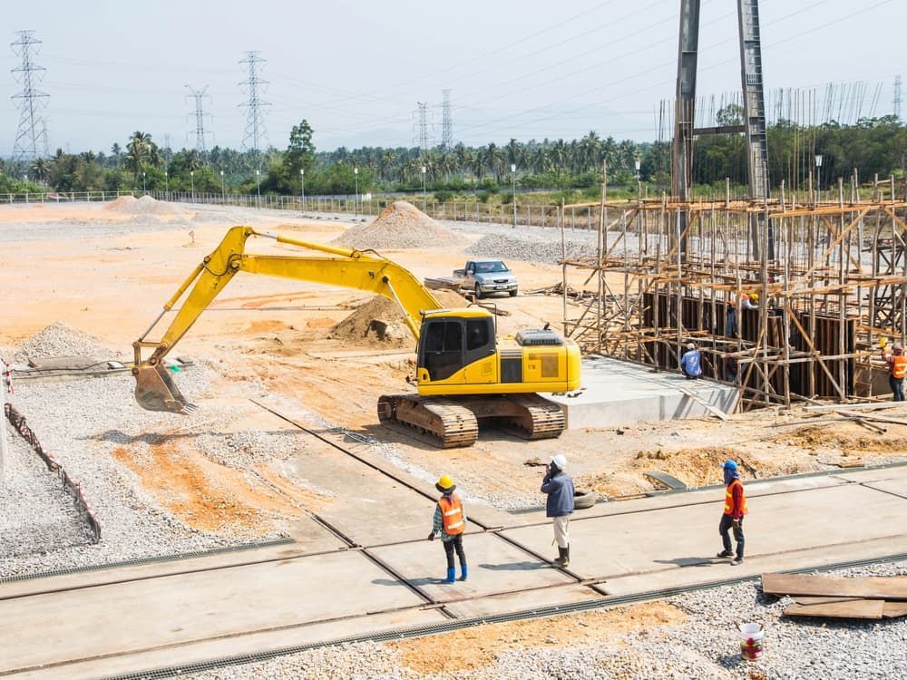 Yellow Excavator on Construction Site With Workers — Dirt Werx in Kiama, NSW