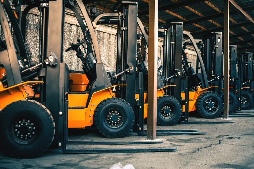 Row of Orange and Black Forklifts Parked Under a Shelter — Dirt Werx in Nowra, NSW