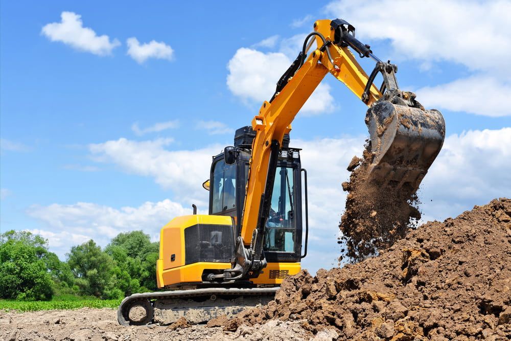 Yellow Excavator Digging Dirt — Dirt Werx in Tathra, NSW