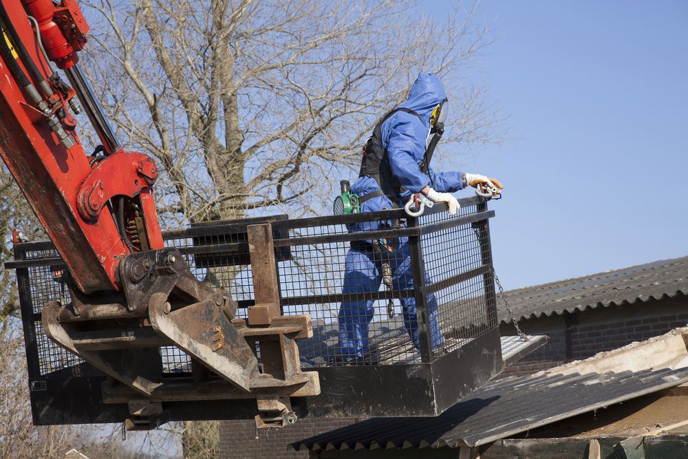 Worker In Blue Gear Stands On A Raised Platform — Dirt Werx in Wollongong, NSW
