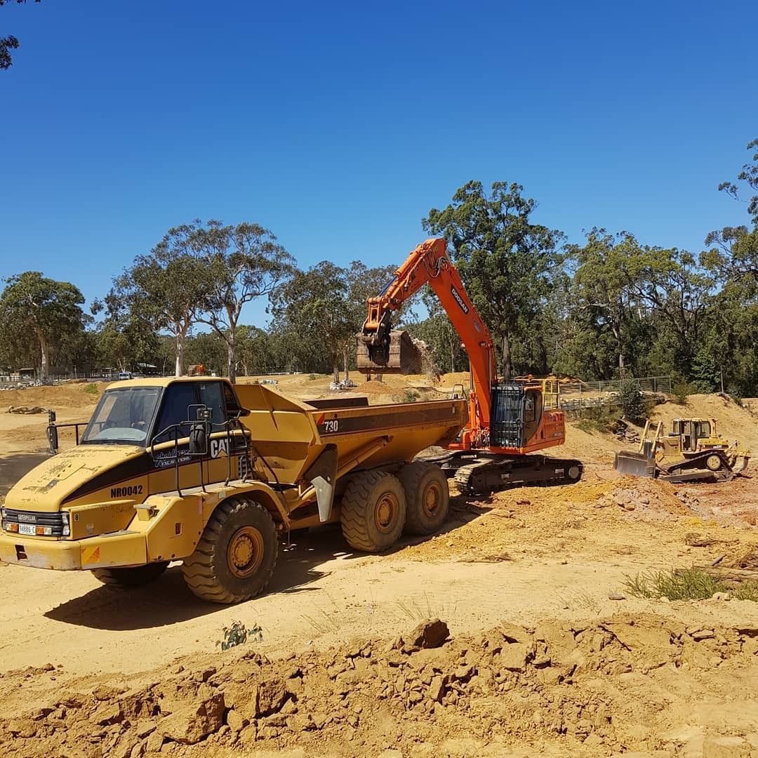 Construction Site With an Orange Excavator