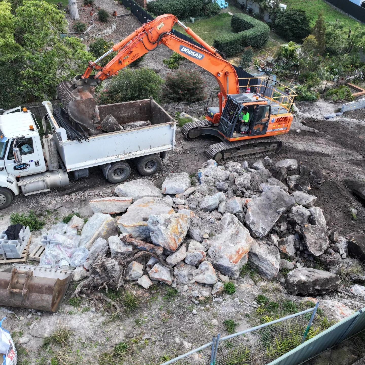 Orange Excavator After Demolishing A Site — Dirt Werx in Wollongong, NSW