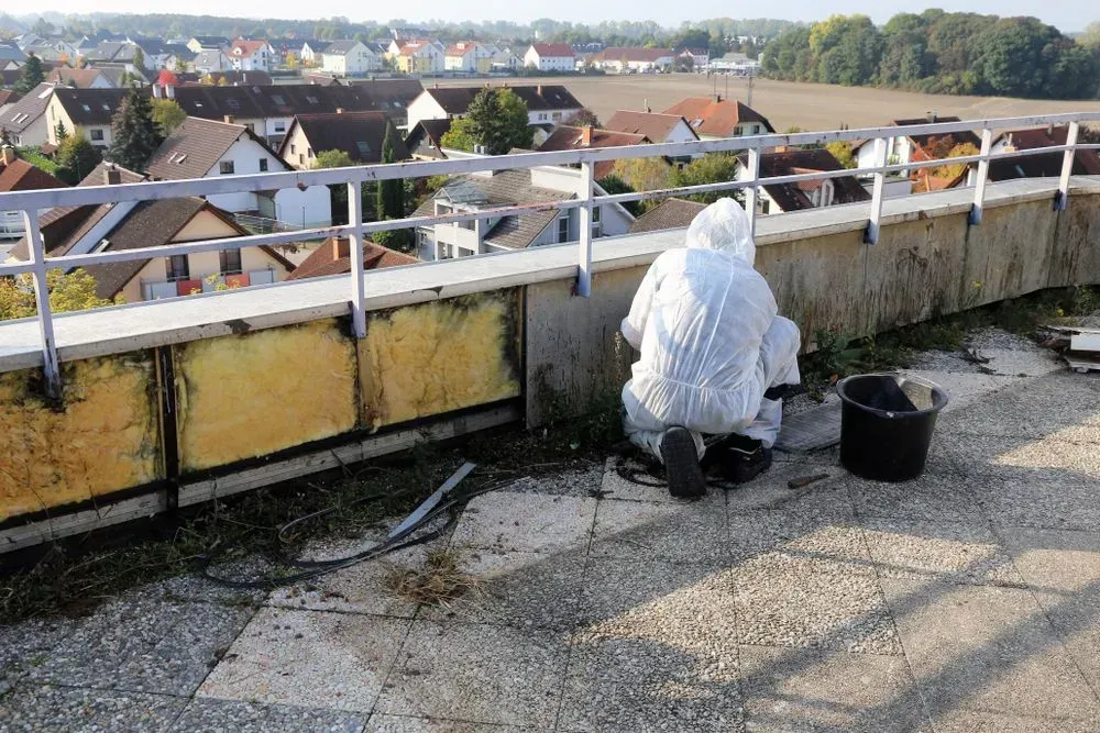 Worker Conducting Asbestos Removal In Wollongong On Rooftop