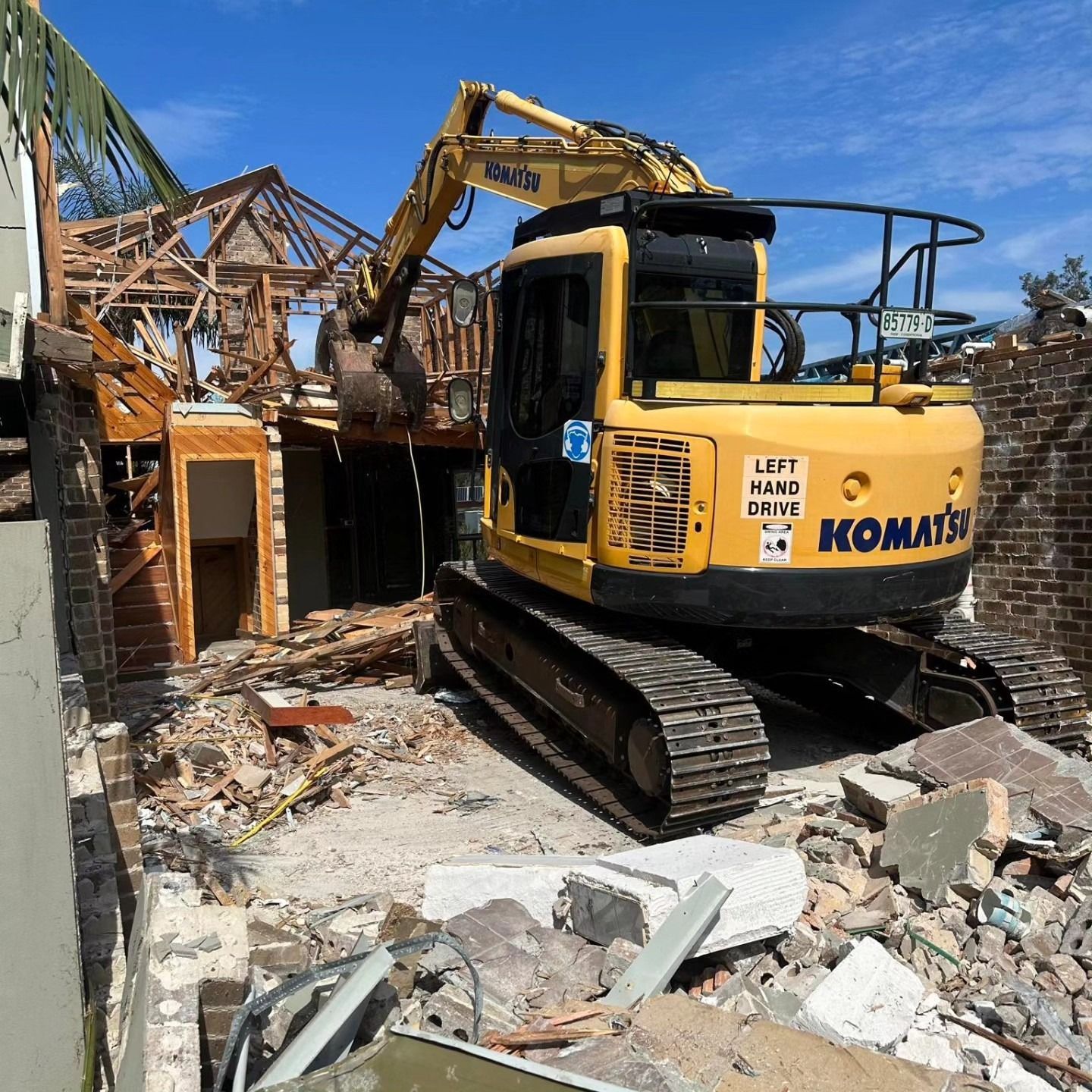 Yellow Excavator Demolishing A House — Dirt Werx in Wollongong, NSW