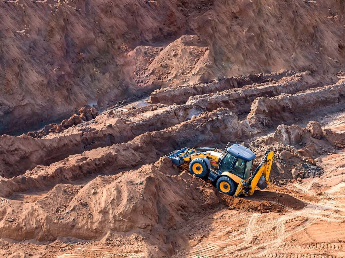 Backhoe Excavator Working on a Hillside, Scooping Dirt; Sunny Day — Dirt Werx in Nowra, NSW