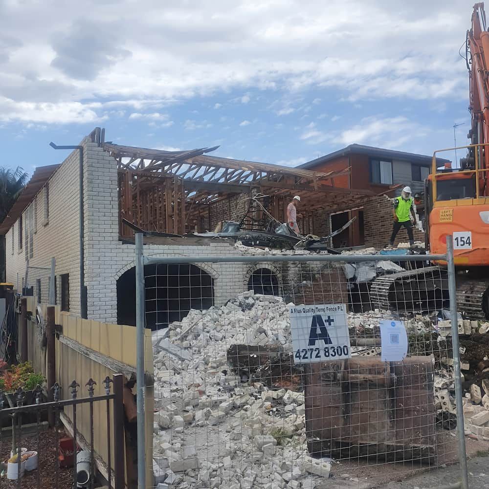 Building demolition; white brick building with wooden frame exposed — Dirt Werx in Nowra, NSW