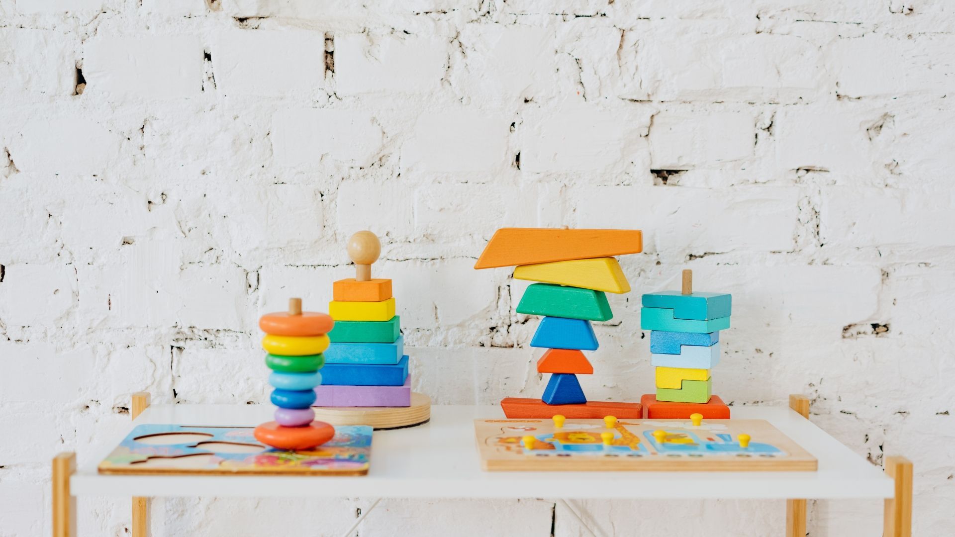 a stack of rainbow childrens puzzles and building blocks