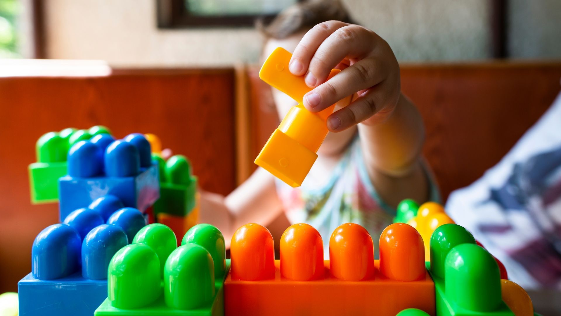 a small child is playing with colorful building blocks