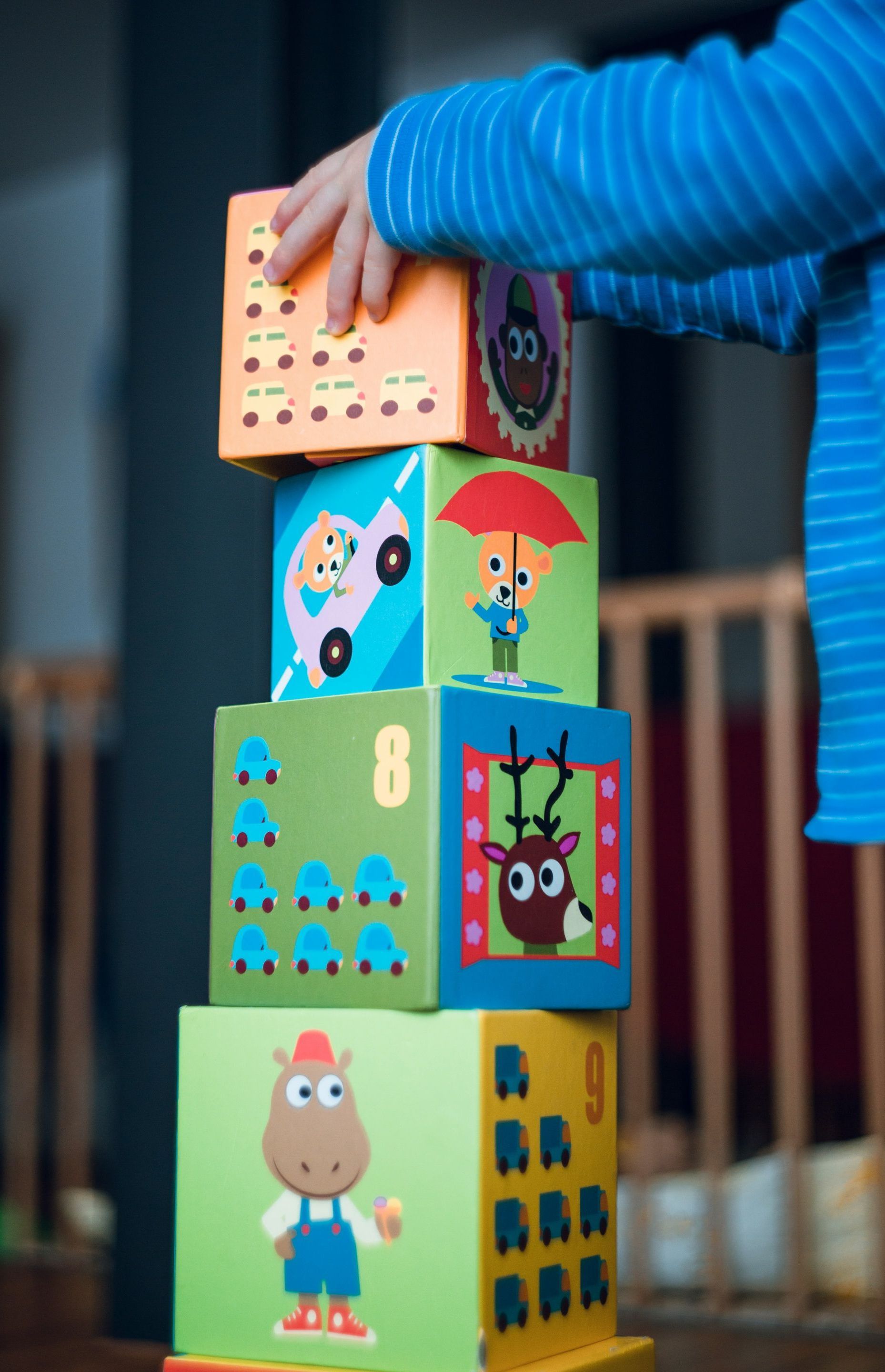 A child is stacking blocks on top of each other.