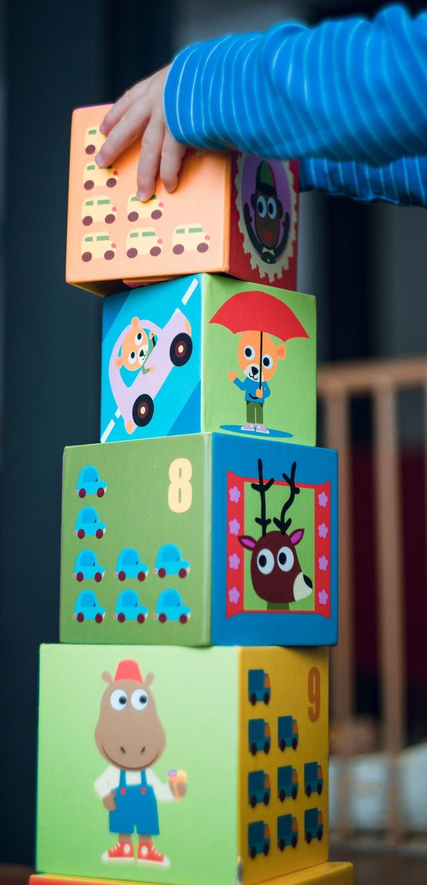 A child is stacking blocks on top of each other.