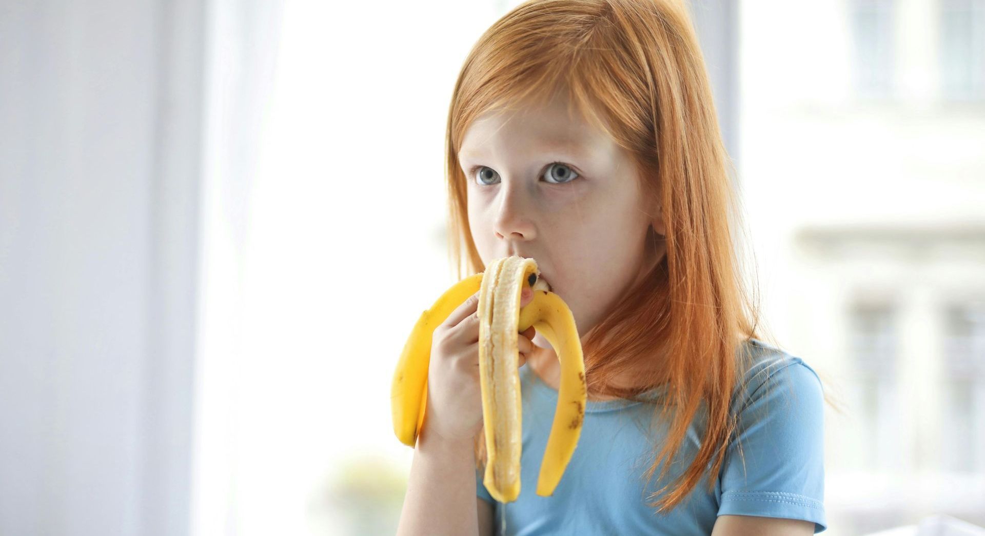 girl eating a banana