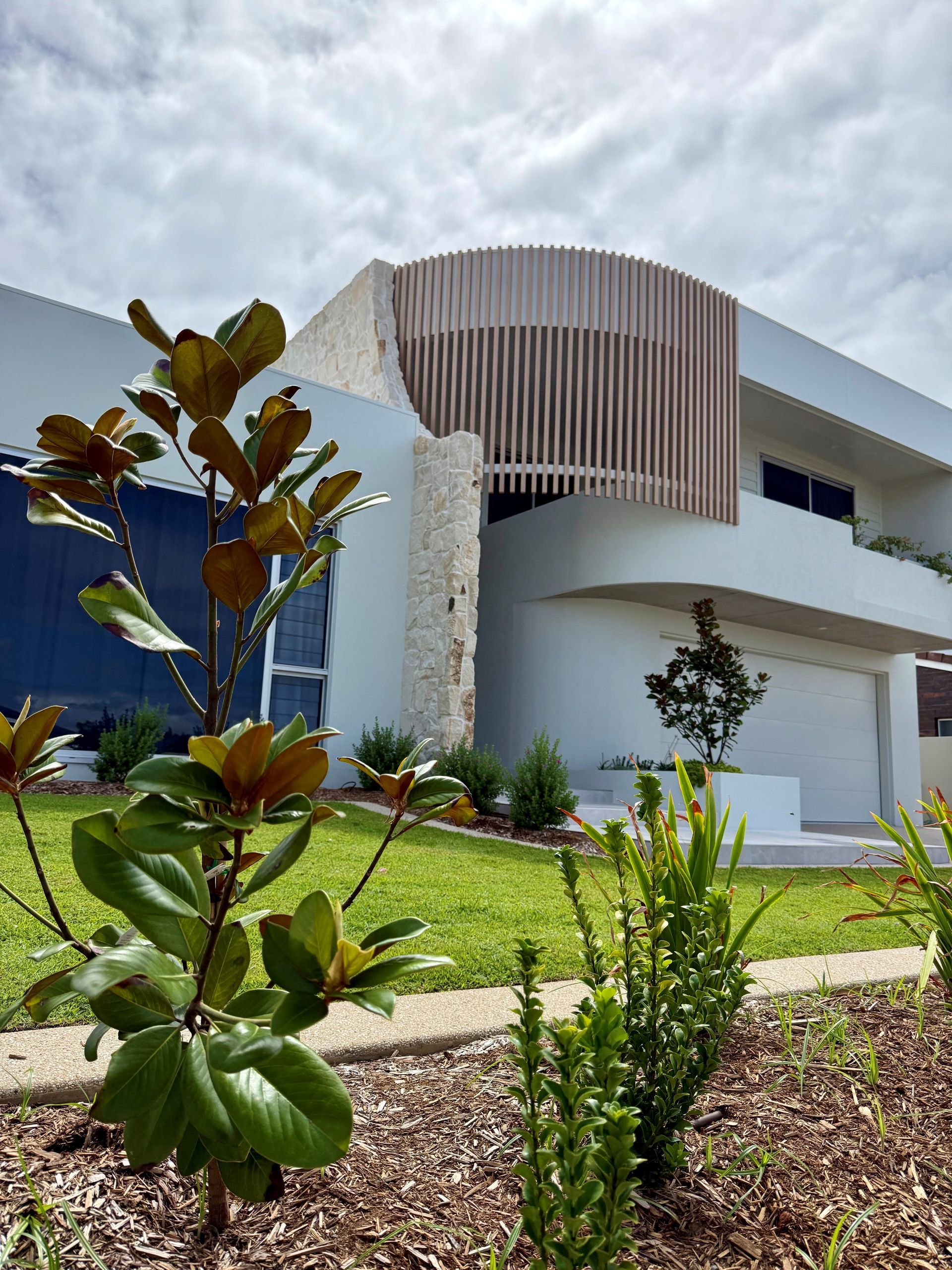 Modern White Building with Curved Wooden Facade — Gatley Building Design in Bundaberg East, QLD